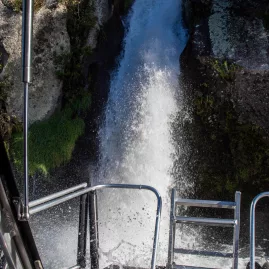 Close-up view of a waterfall splashing onto the rear deck of a boat on Lake Taupō