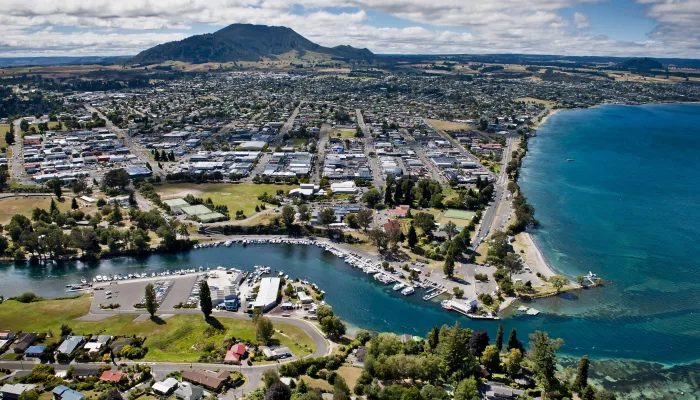 Aerial view of Taupō Boat Harbour, town centre, and Mount Tauhara beside the shores of Lake Taupō in New Zealand.