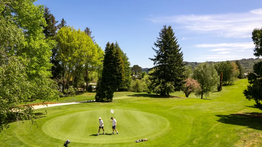 Golfers on the green at Tūrangi Golf Club, New Zealand.