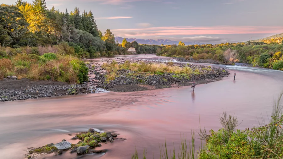 Anglers fishing at sunrise on the Tongariro River, New Zealand.