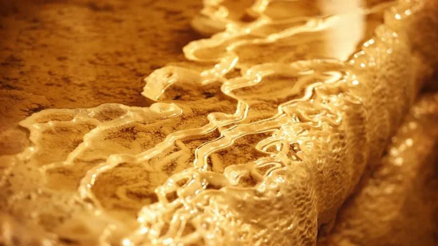 Golden limestone terraces and cave pools in Aranui Cave, Waitomo