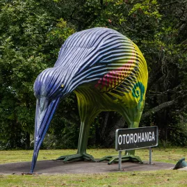 Large painted kiwi bird sculpture near the welcome sign in Otorohanga, New Zealand