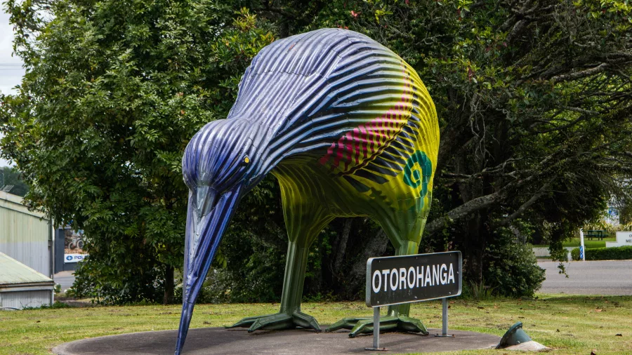 Large painted kiwi bird sculpture near the welcome sign in Otorohanga, New Zealand