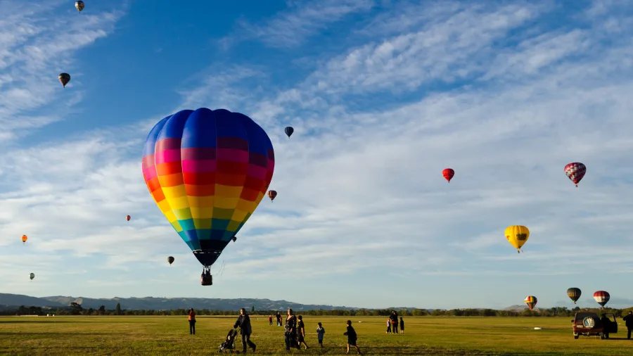 Aerial view of hot air balloons floating over a Wairarapa town in the Wellington Region, New Zealand