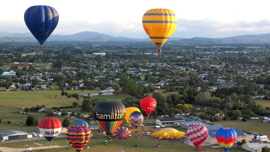 Hot air balloons taking off over the Wairarapa countryside in the Wellington Region, New Zealand