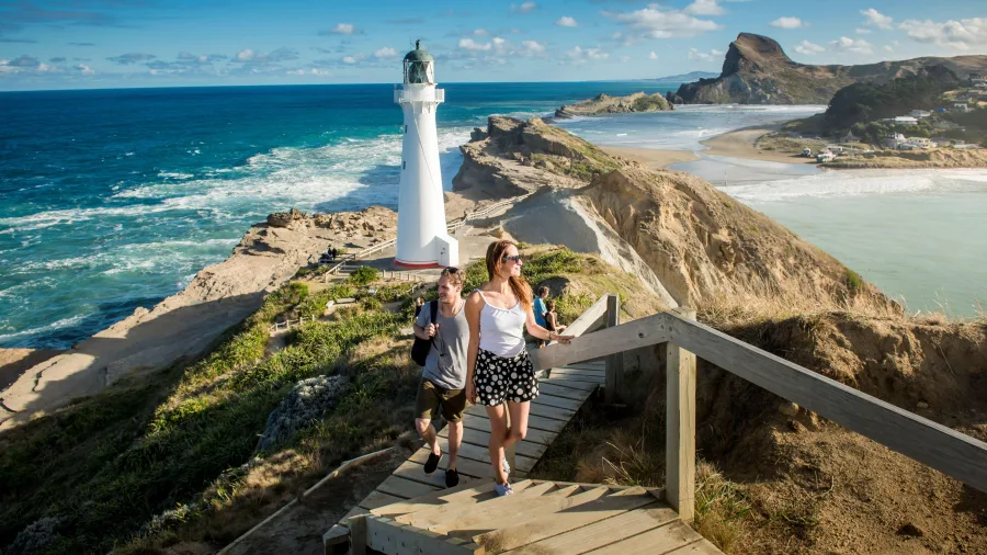 Couple walking up steps from the Castlepoint Lighthouse on the Wairarapa coast