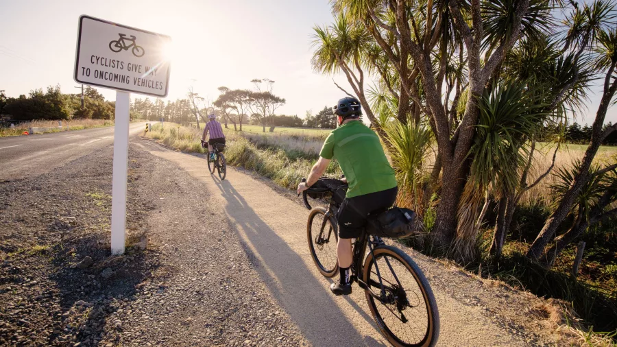 Cyclists riding the Remutaka Cycle Trail between Cross Creek and Featherston at sunset: Credit Caleb Smith Photography