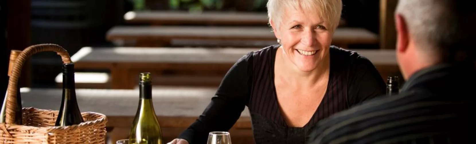 Couple dining with wine and platters at Martinborough winery