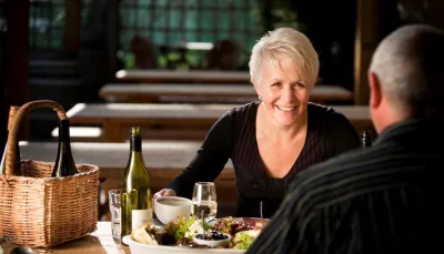 Couple dining with wine and platters at Martinborough winery