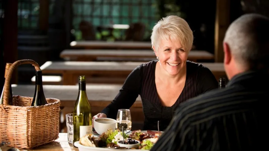 Couple dining with wine and platters at Martinborough winery