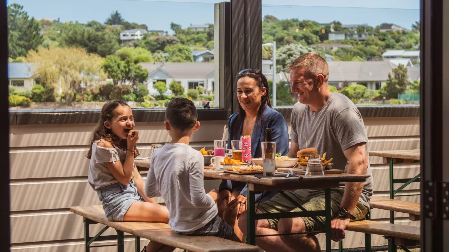 Family enjoying lunch together at The Co-Op Kitchen & Bar in Porirua Wellington