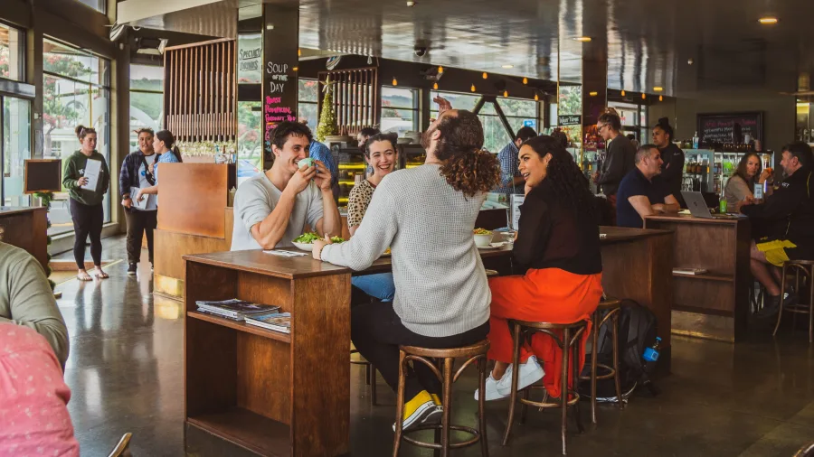 Diners enjoying meals at the Peppermill Café interior, Porirua