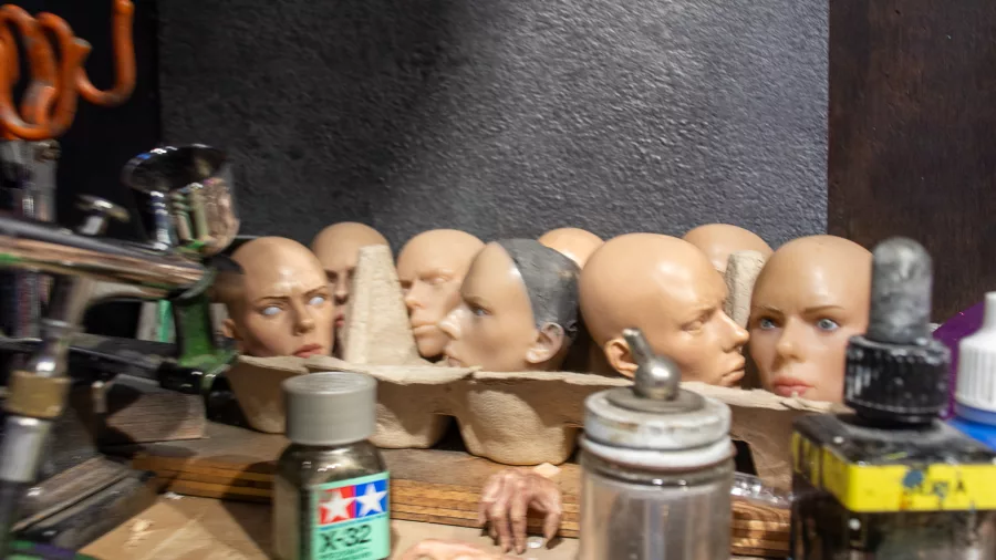 Silicone character heads arranged in an egg tray at Wētā Workshop