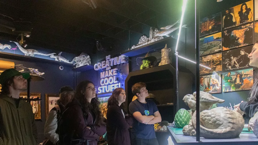 Tour group observing film props at Wētā Workshop in Wellington