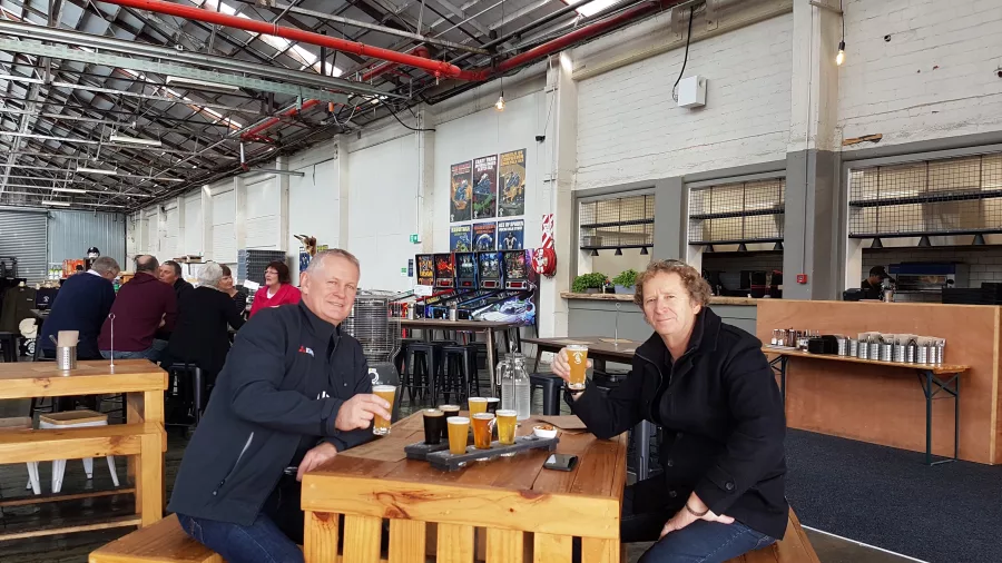 Two men enjoying a craft beer tasting paddle at Boneface Brewery in Upper Hutt
