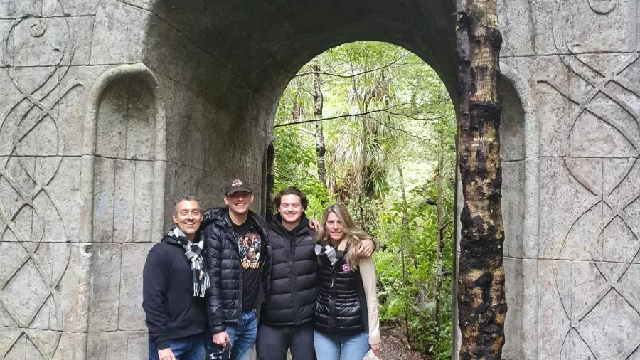 Group photo at the stone archway marking the entrance to Rivendell filming location