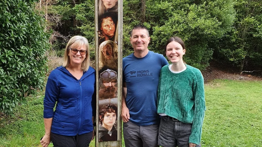 Family at Rivendell height check totem in Kaitoke Regional Park, Wellington