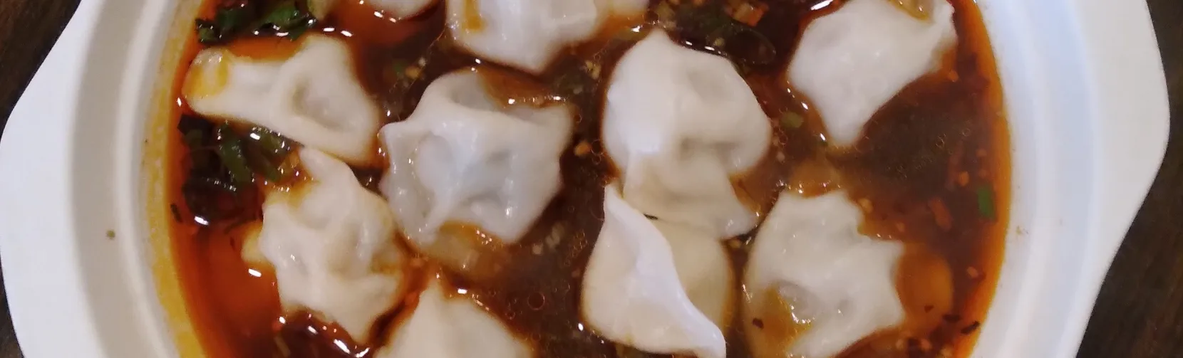 Dumplings served in spicy chilli oil broth at a Wellington eatery