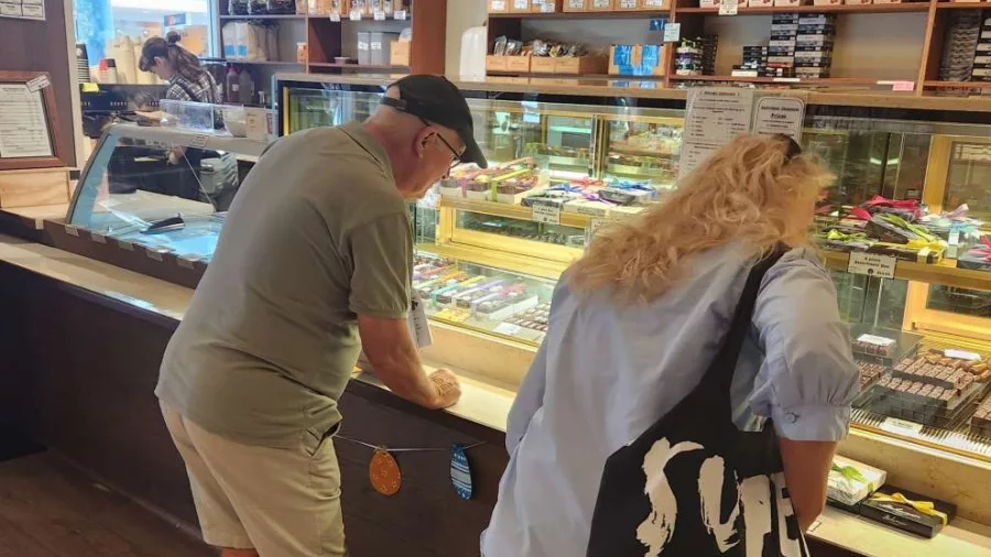Couple browsing handcrafted chocolates at Wellington store
