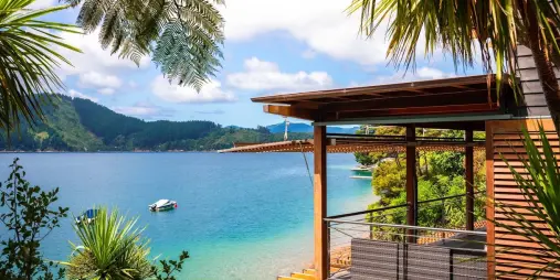 Private deck overlooking the calm waters of Marlborough Sounds on a sunny day