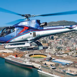 Helicopter flying over Wellington city, with views of the harbour and stadium