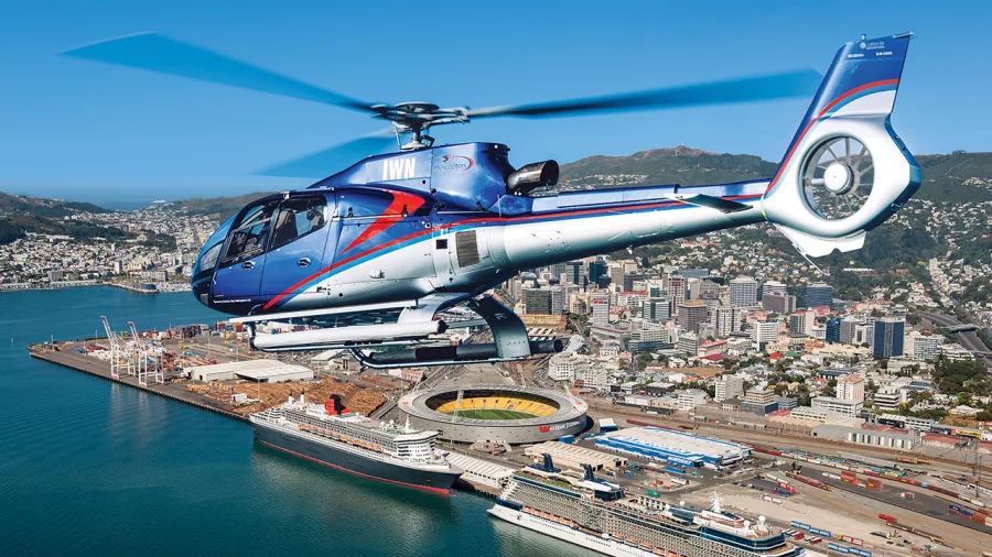 Helicopter flying over Wellington city, with views of the harbour and stadium