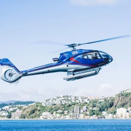 A helicopter flying over Wellington’s coastal suburbs on a clear day