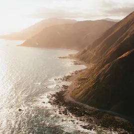 Wellington coastal road at sunrise with cliffs meeting the sea