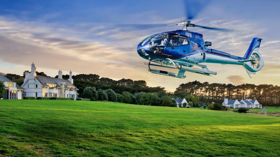 Helicopter arriving at Wharekauhau Lodge during golden hour in Wellington