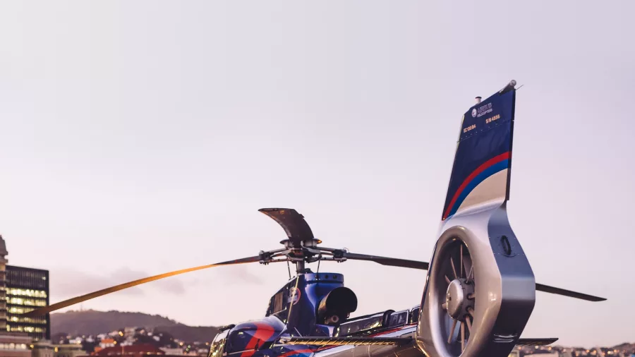 Helicopter parked by Wellington Harbour at dusk
