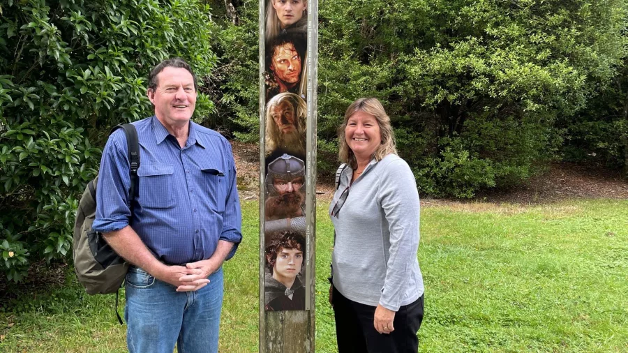 Two visitors standing beside the Lord of the Rings film marker at Rivendell in Kaitoke Regional Park
