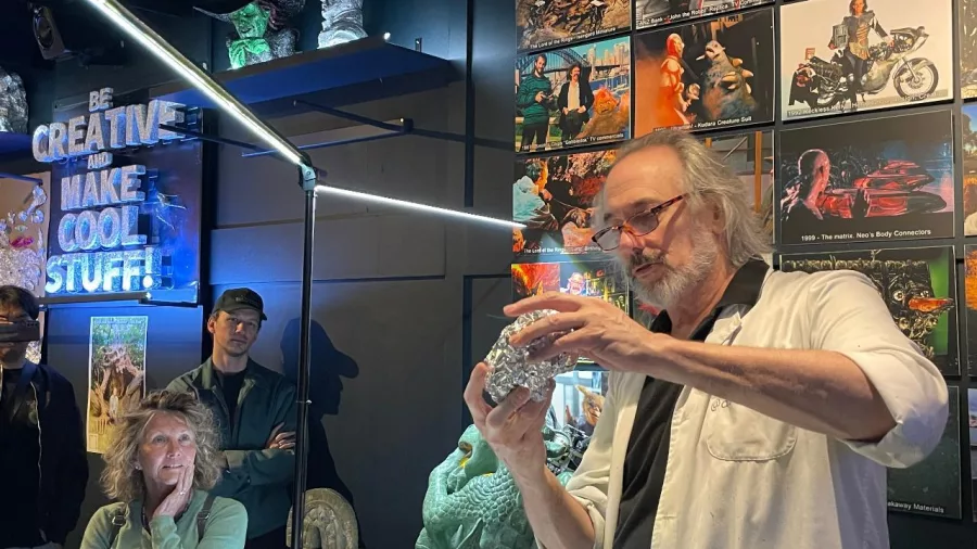 Wētā Workshop artist demonstrating sculpting techniques to visitors