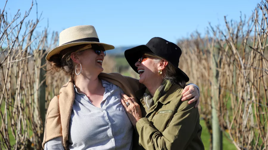 Two women laughing and enjoying their time at Poppies Martinborough vineyard