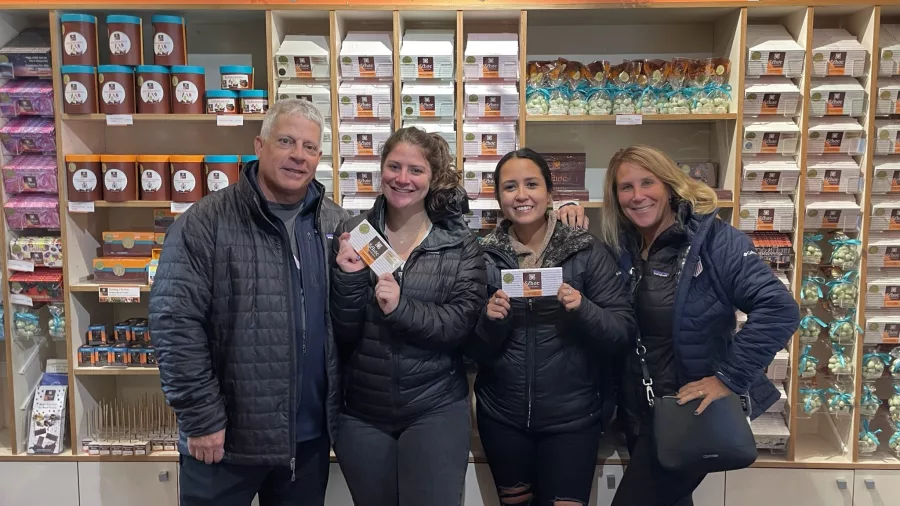 Group of travellers smiling and holding chocolate at Shoc Chocolate in Greytown