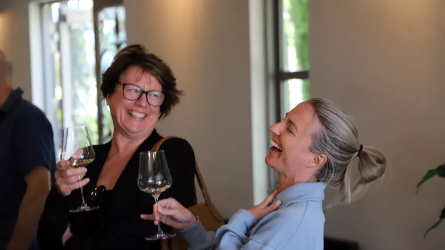 Two women laughing during a wine tasting session in Martinborough
