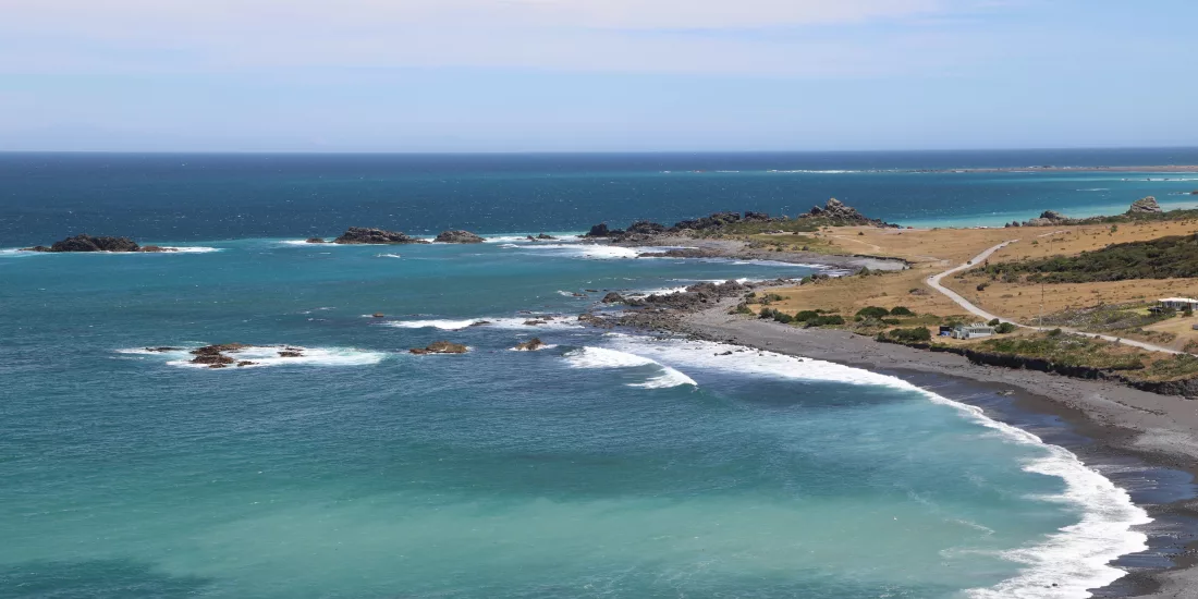 Turquoise waters in a sheltered cove at Cape Palliser