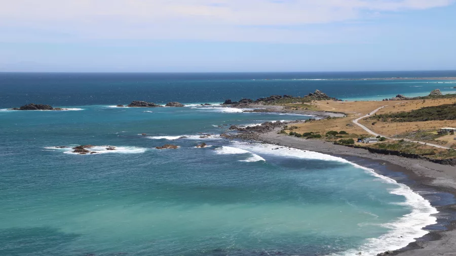 Turquoise waters in a sheltered cove at Cape Palliser