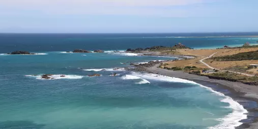 Turquoise waters in a sheltered cove at Cape Palliser