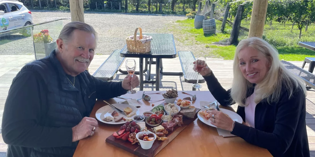 Couple enjoying wine and a platter lunch at Le Gra Vineyard in Opaki, Wairarapa