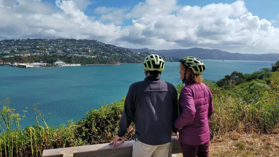 Couple wearing helmets enjoying a coastal lookout over Wellington Harbour from Miramar Peninsula