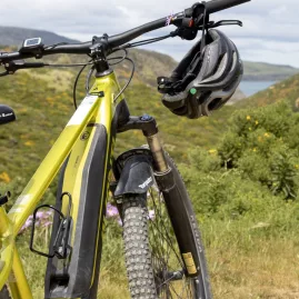E‑bike parked on trail with Pencarrow scenery in background