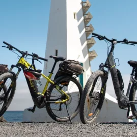 Line of e-bikes parked in front of Pencarrow Lighthouse in Wellington