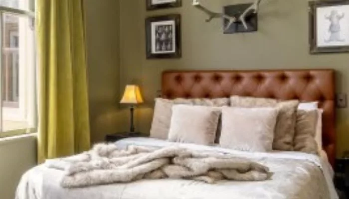 Elegant hotel room at The Royal Hotel Martinborough with chandelier and antler wall decor