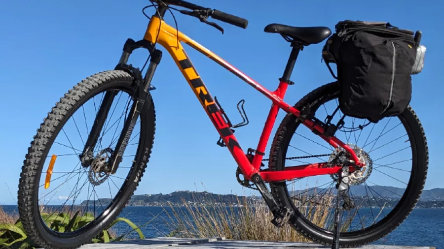 Trek mountain bike with pannier parked by the sea in Wellington