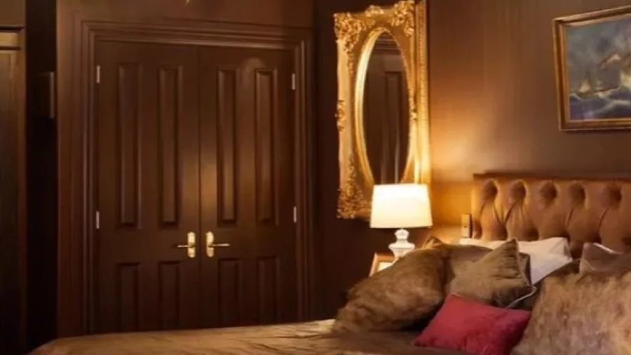 Luxurious dark-toned bedroom suite at The Royal Hotel in Martinborough