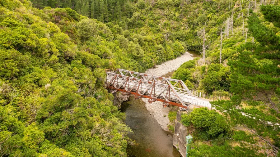 Historic wooden rail bridge surrounded by forest along the Remutaka Cycle Trail in Hutt Valley