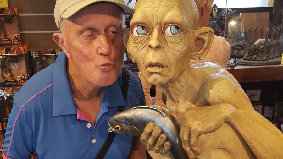 Visitor posing with Gollum statue holding a fish at Wētā Workshop in Wellington