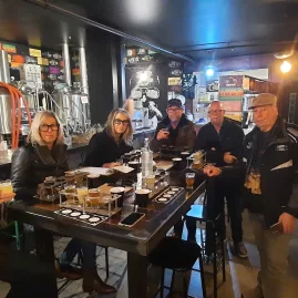 Small group enjoying a craft beer tasting at a brewery in Wellington