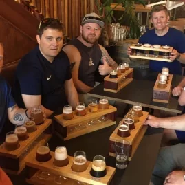 Group of men enjoying a craft beer tasting session in Wellington