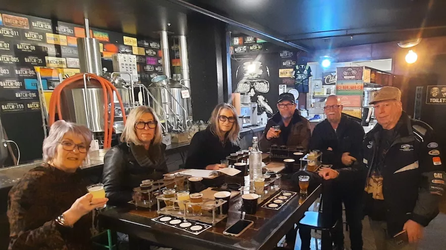 Small group enjoying a craft beer tasting at a brewery in Wellington